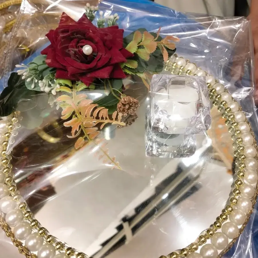 Ring box with a red rose on a mirror tray